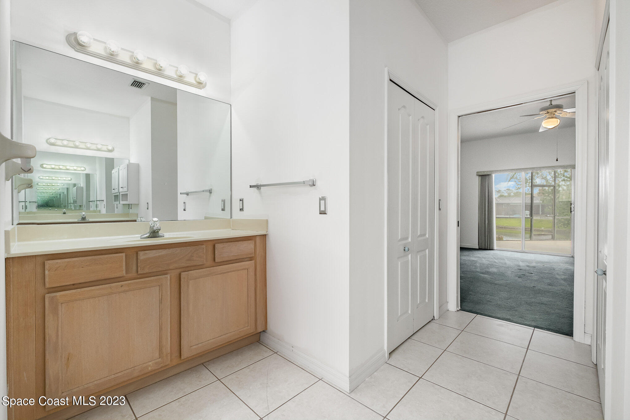 128 Palm Circle Melbourne, FL 32940 - Photo 21 of 30 a spacious bathroom with a granite countertop sink mirror and