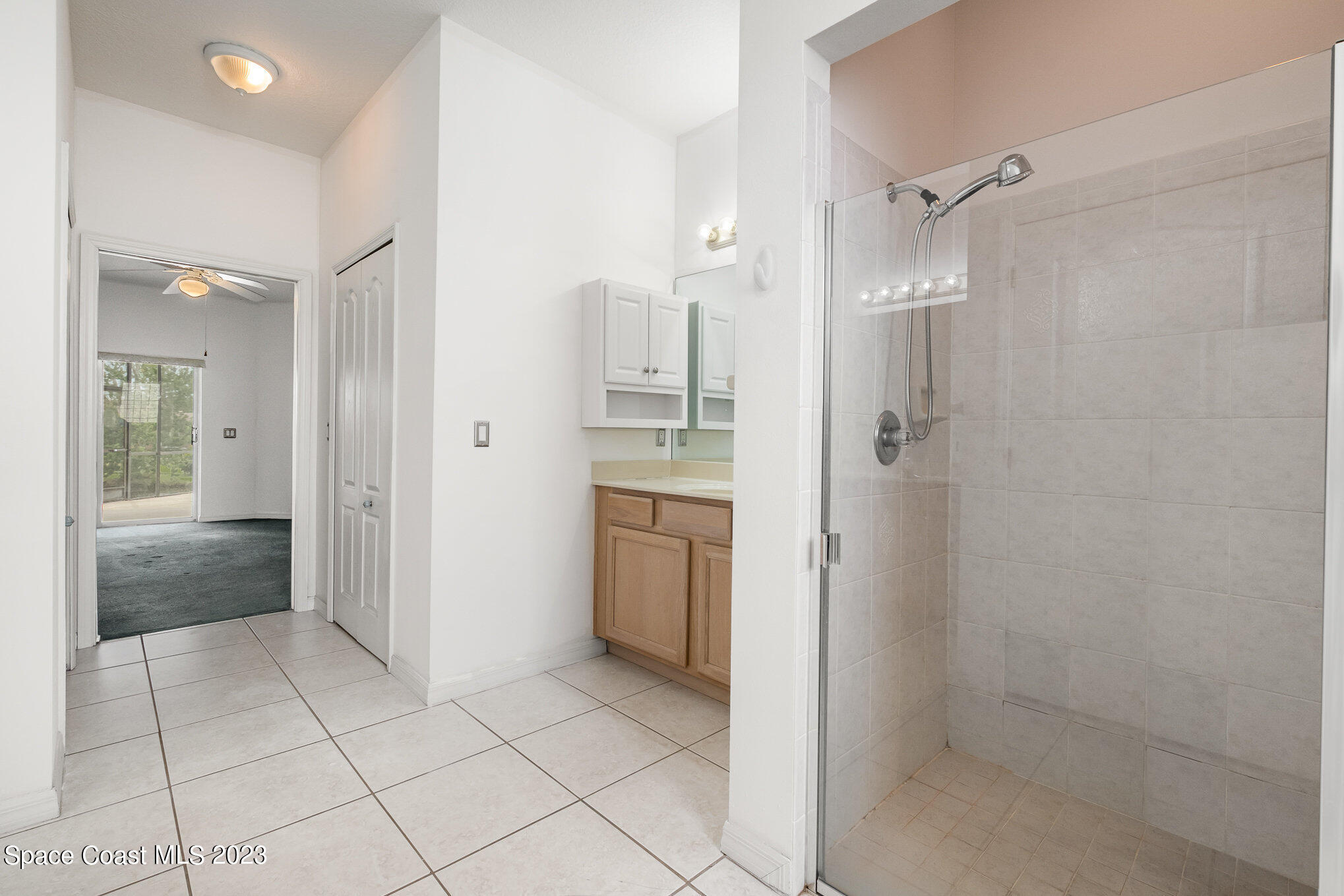 128 Palm Circle Melbourne, FL 32940 - Photo 22 of 30 a bathroom with a granite countertop sink mirror and shower
