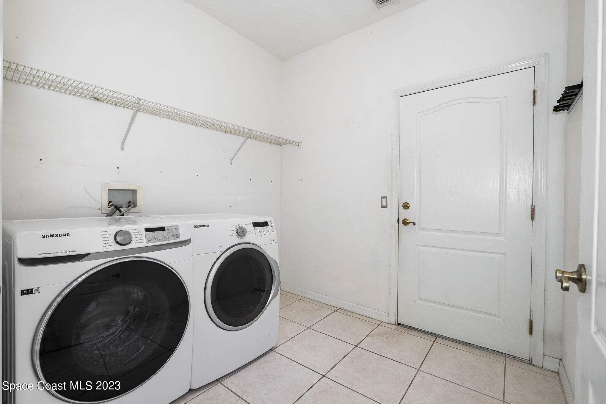 128 Palm Circle Melbourne, FL 32940 - Photo 25 of 30 a view of a storage & utility room with washer and dryer