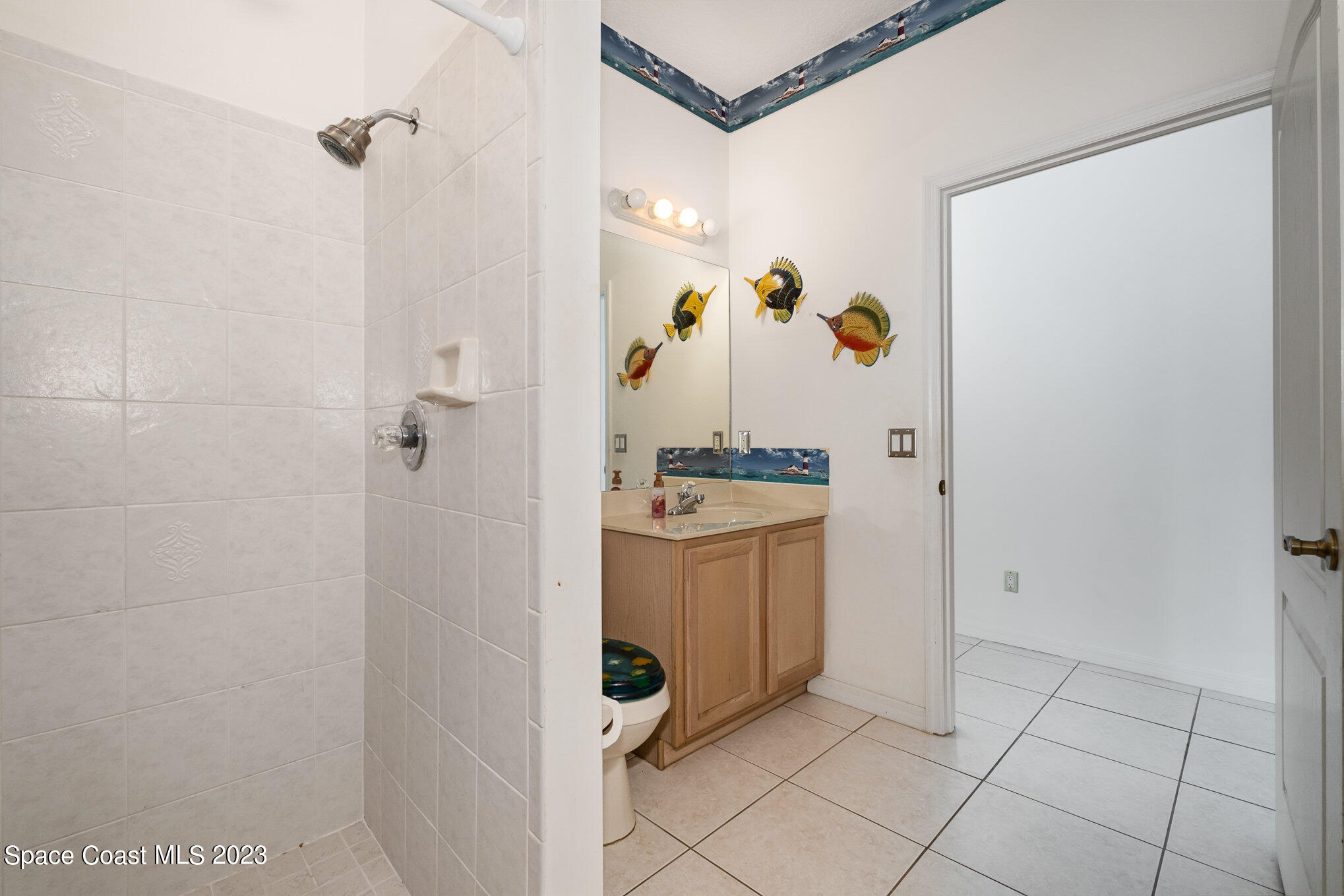 128 Palm Circle Melbourne, FL 32940 - Photo 26 of 30 a bathroom with a shower and mirror