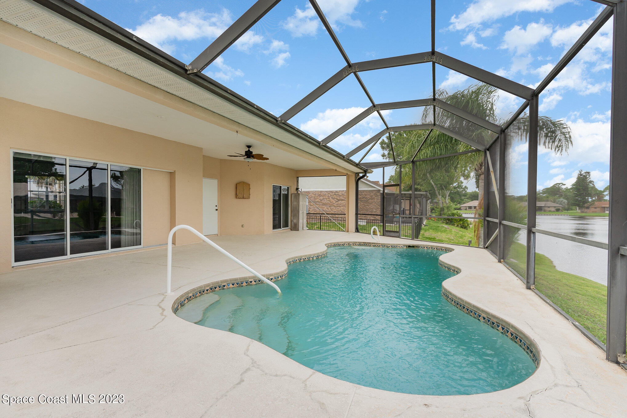 128 Palm Circle Melbourne, FL 32940 - Photo 27 of 30 a view of a swimming pool with a patio