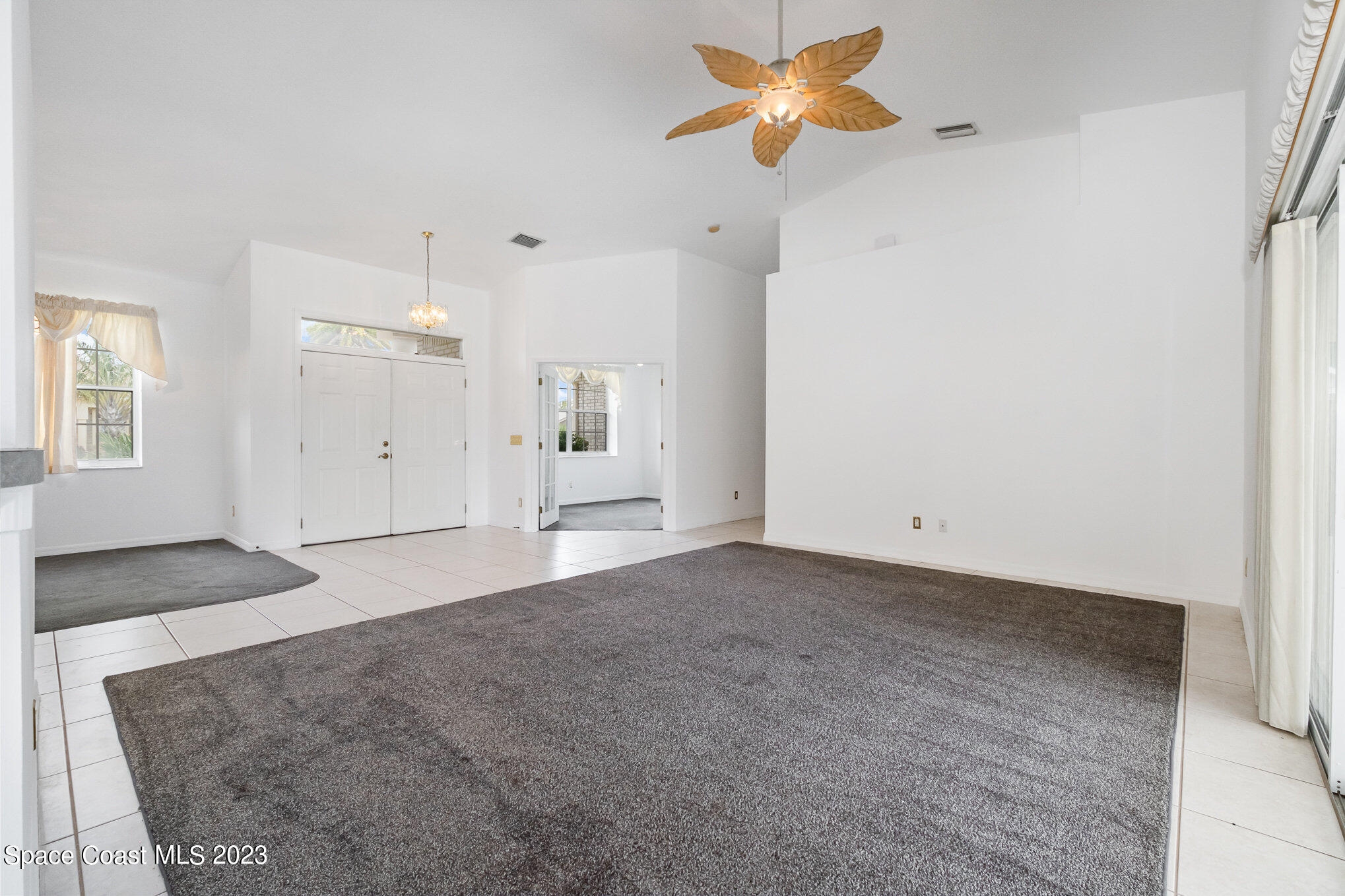 128 Palm Circle Melbourne, FL 32940 - Photo 8 of 30 a view of empty room with a ceiling fan