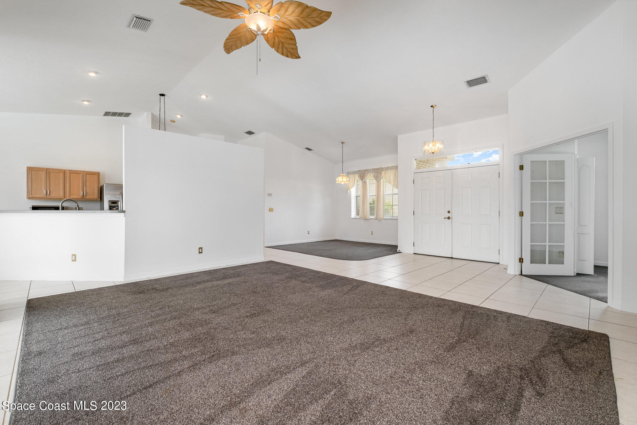 128 Palm Circle Melbourne, FL 32940 - Photo 10 of 30 a view of an empty room with a kitchen