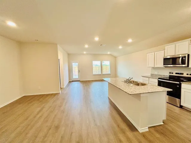a kitchen with a sink and a stove top oven