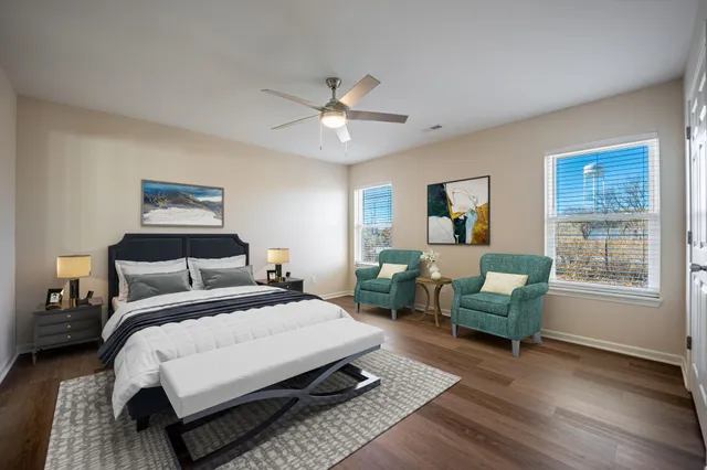 a bedroom with a bed a couch and a window