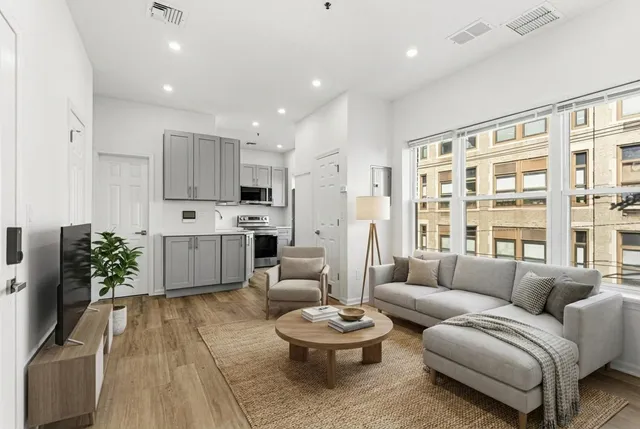 a living room with furniture and a large window