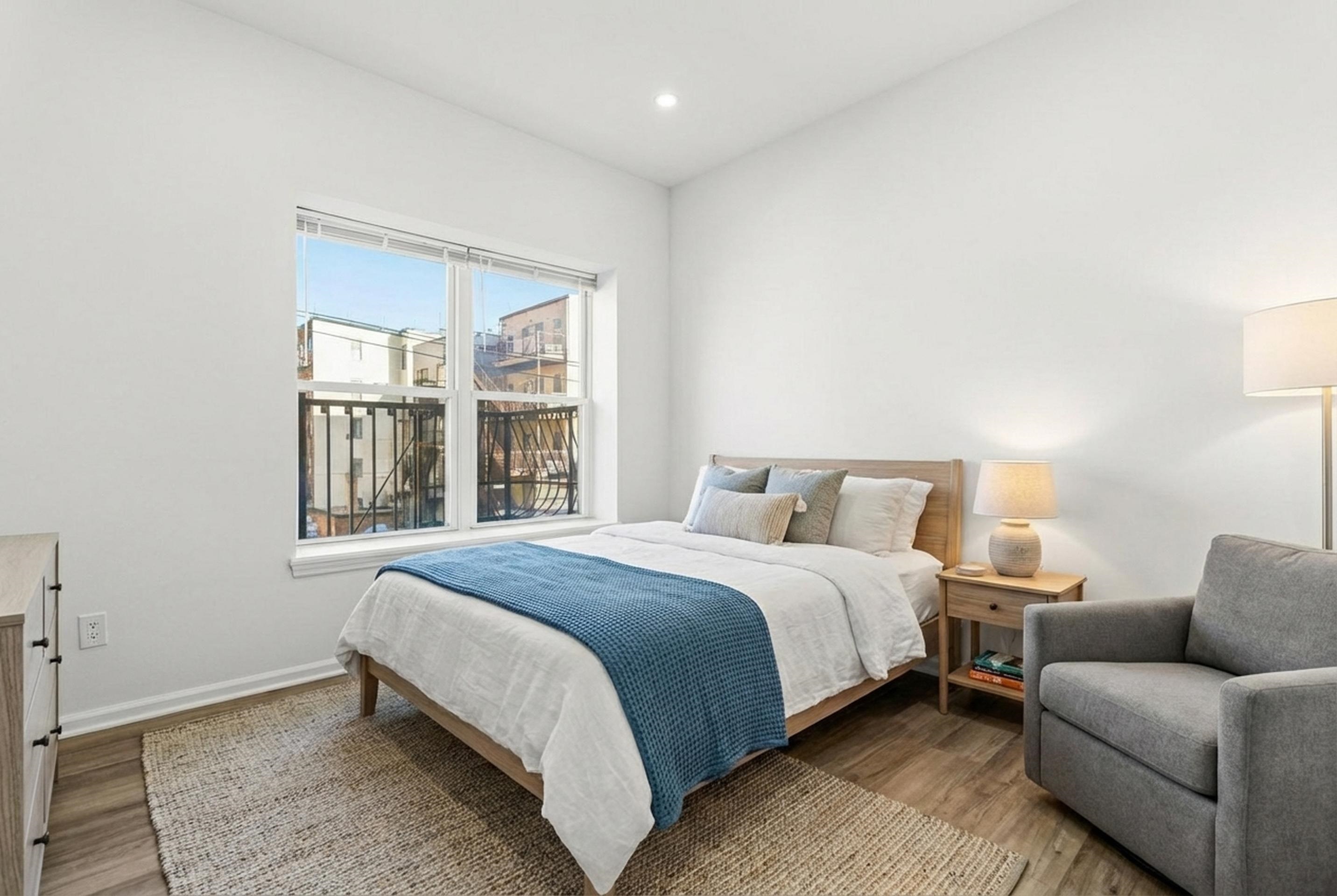 419 5th Street, Unit C Hoboken, NJ 07030 - Photo 11 of 16 a bed room with a bed and a couch