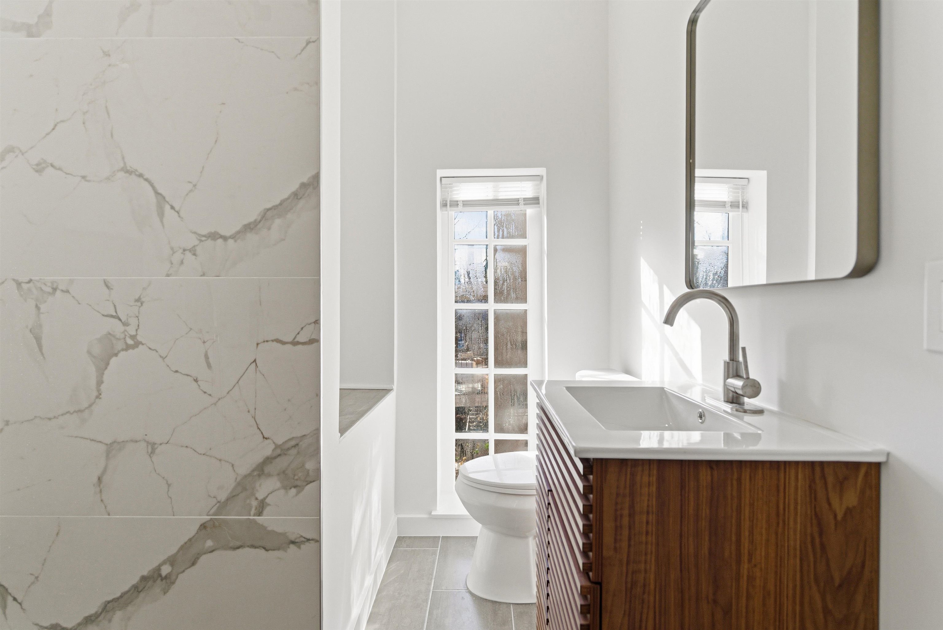 419 5th Street, Unit C Hoboken, NJ 07030 - Photo 12 of 16 a bathroom with a sink and a mirror