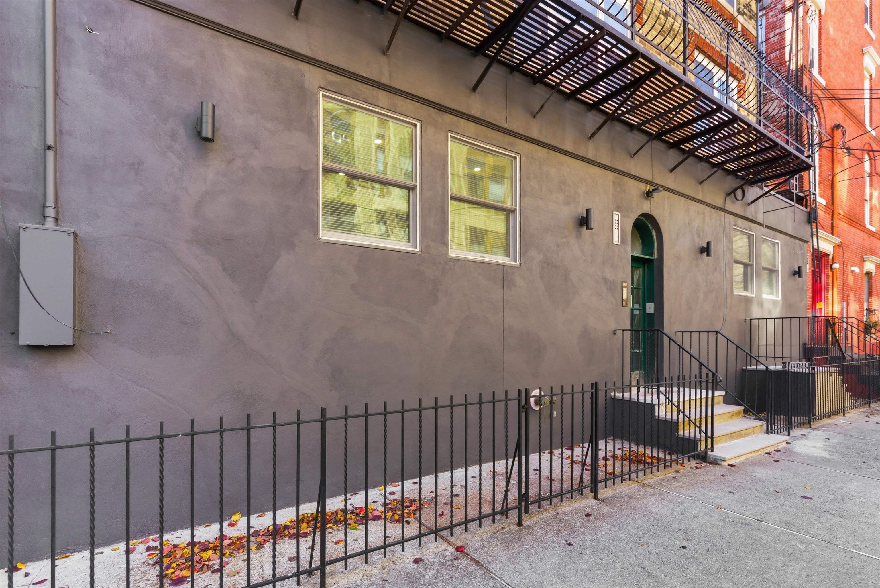419 5th Street, Unit C Hoboken, NJ 07030 - Photo 15 of 16 a view of a house with a wooden fence