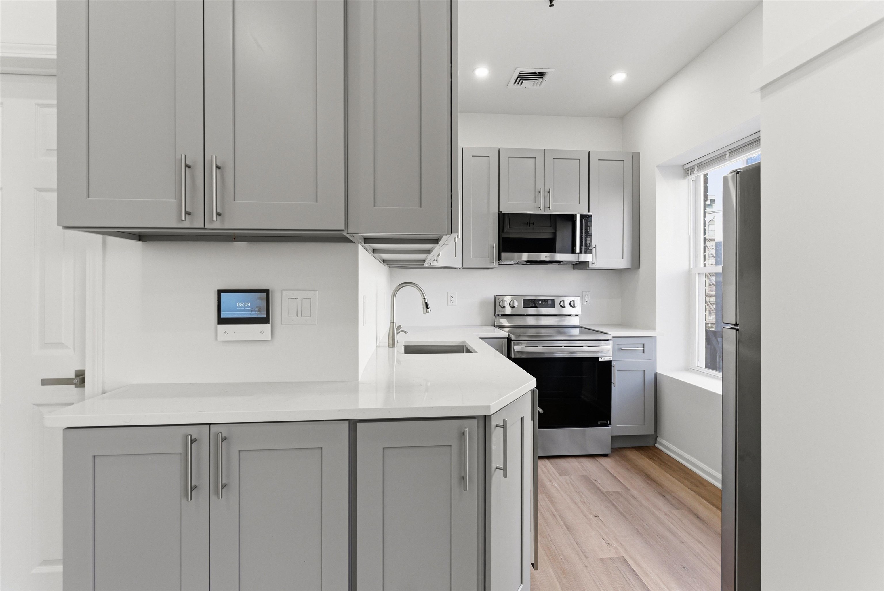 419 5th Street, Unit C Hoboken, NJ 07030 - Photo 2 of 16 a kitchen with stainless steel appliances granite countertop a stove top oven a sink and dishwasher