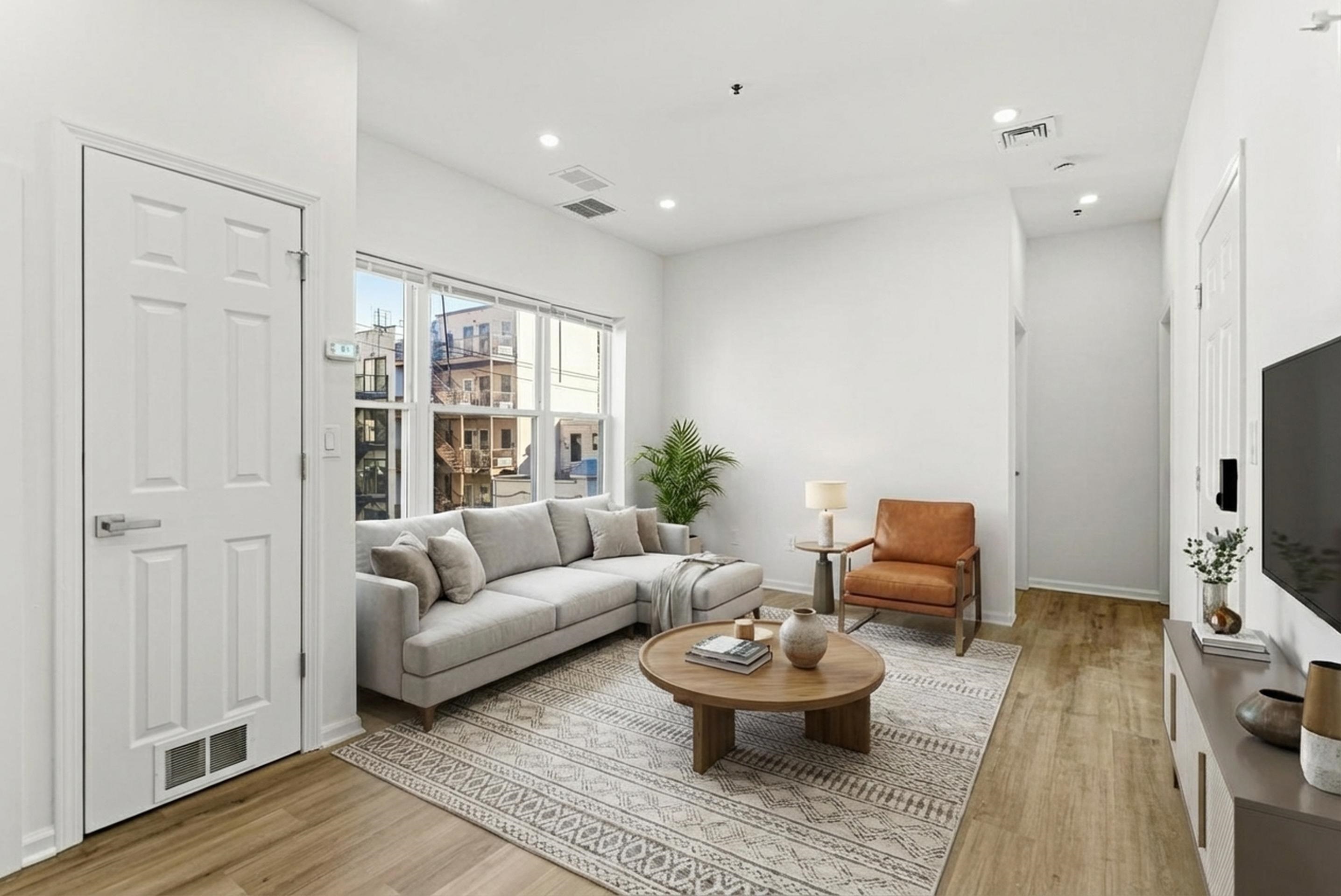 419 5th Street, Unit C Hoboken, NJ 07030 - Photo 7 of 16 a living room with furniture and a flat screen tv