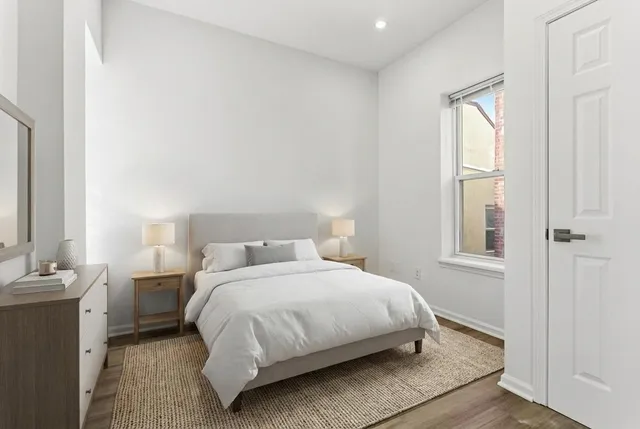 a bedroom with a bed and window