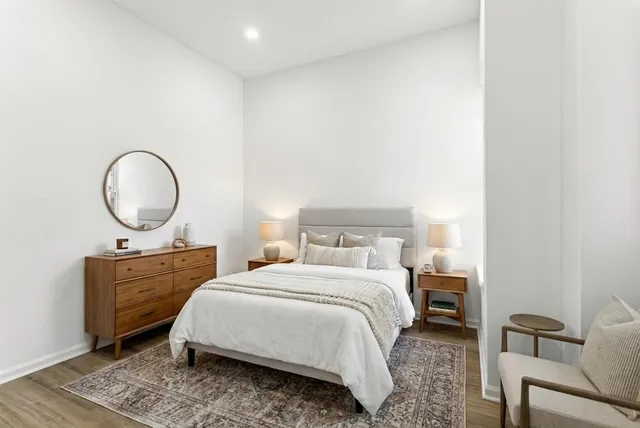 a bedroom with a bed and a chandelier