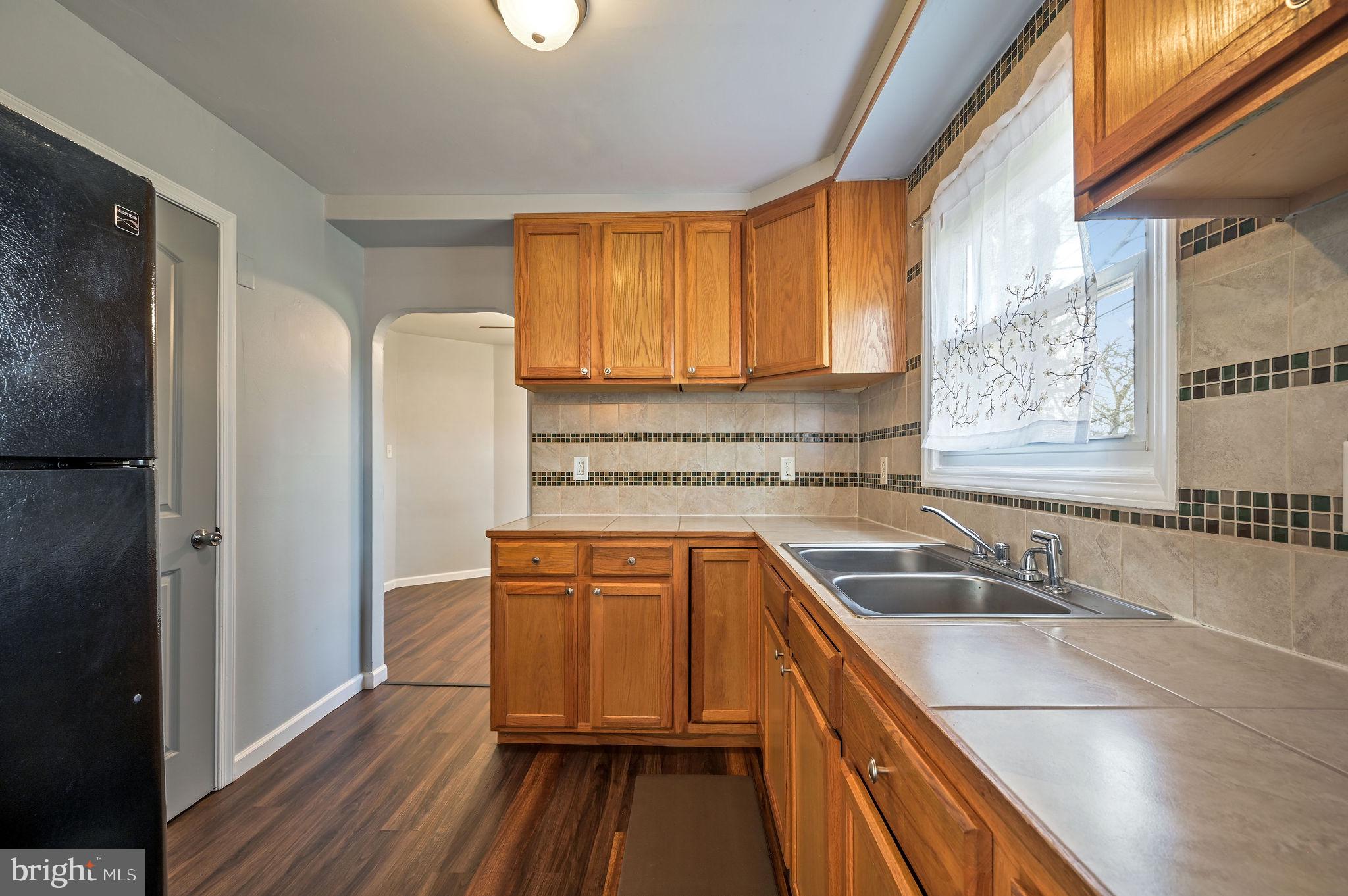 1431 Joshua Clayton Road Dover, DE 19904 - Photo 11 of 31 a kitchen with stainless steel appliances granite countertop a sink and a refrigerator