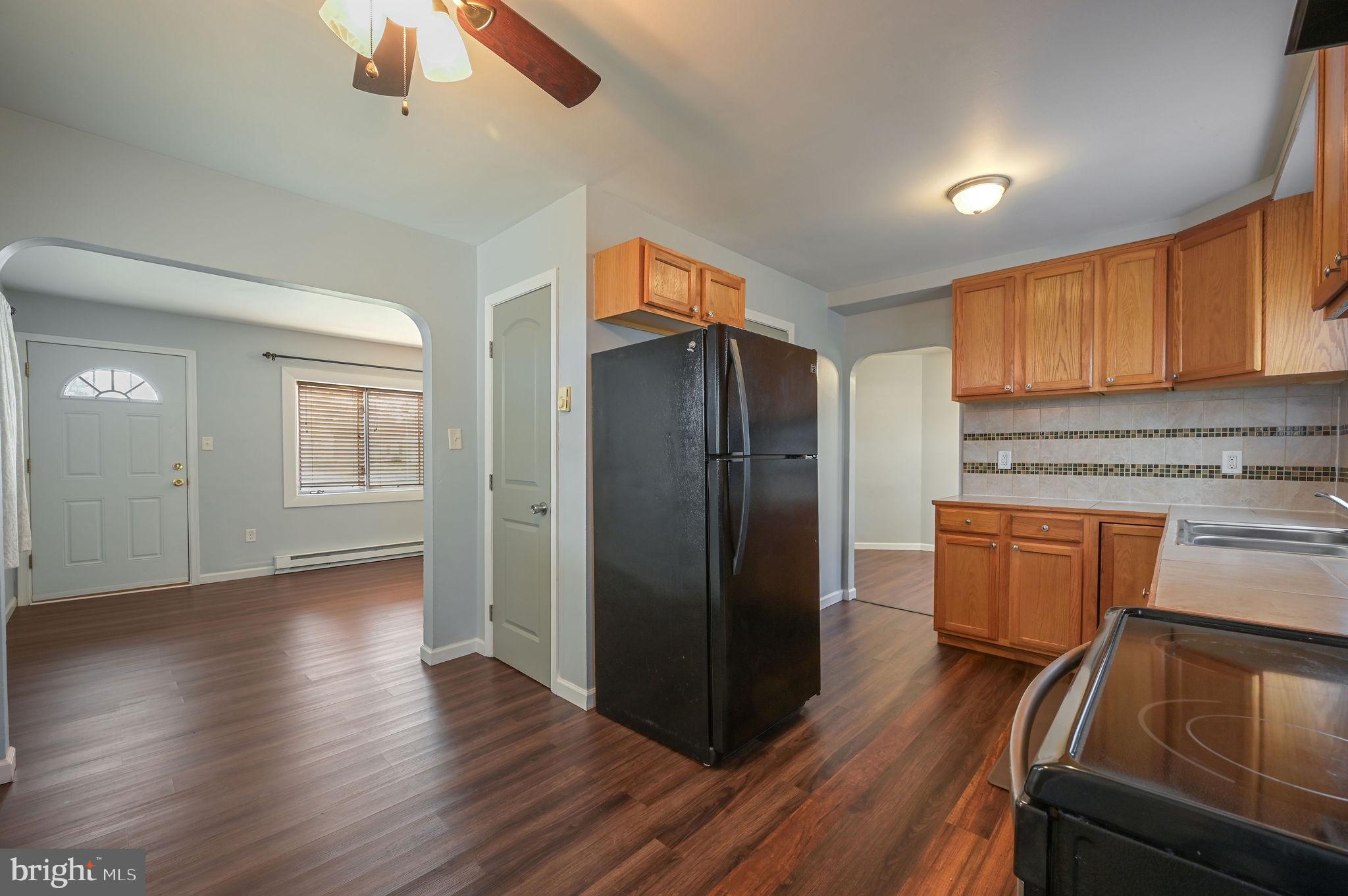 1431 Joshua Clayton Road Dover, DE 19904 - Photo 13 of 31 a kitchen with granite countertop wooden floors and stainless steel appliances