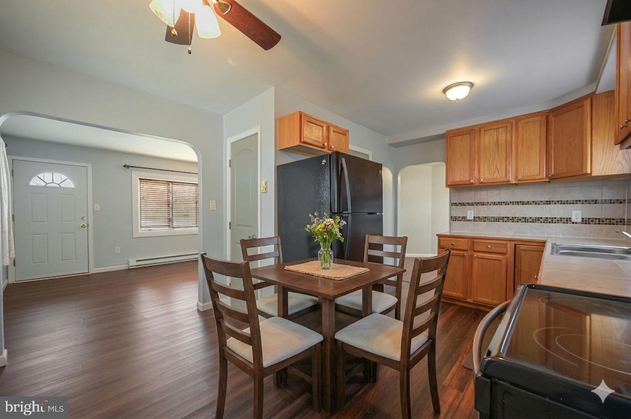 1431 Joshua Clayton Road Dover, DE 19904 - Photo 14 of 31 a view of a dining room with furniture and wooden floor