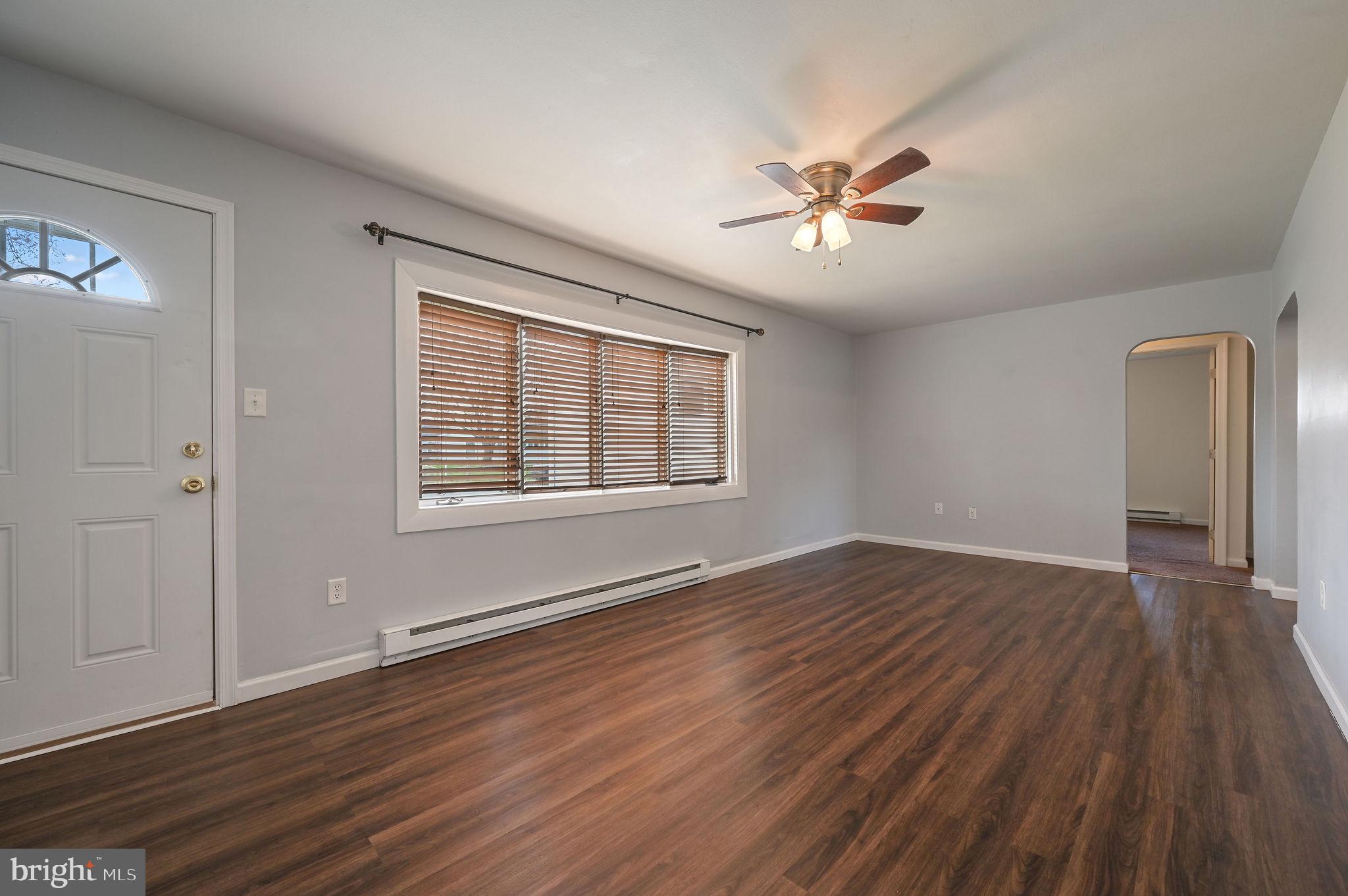 1431 Joshua Clayton Road Dover, DE 19904 - Photo 2 of 31 a view of an empty room with wooden floor and a window