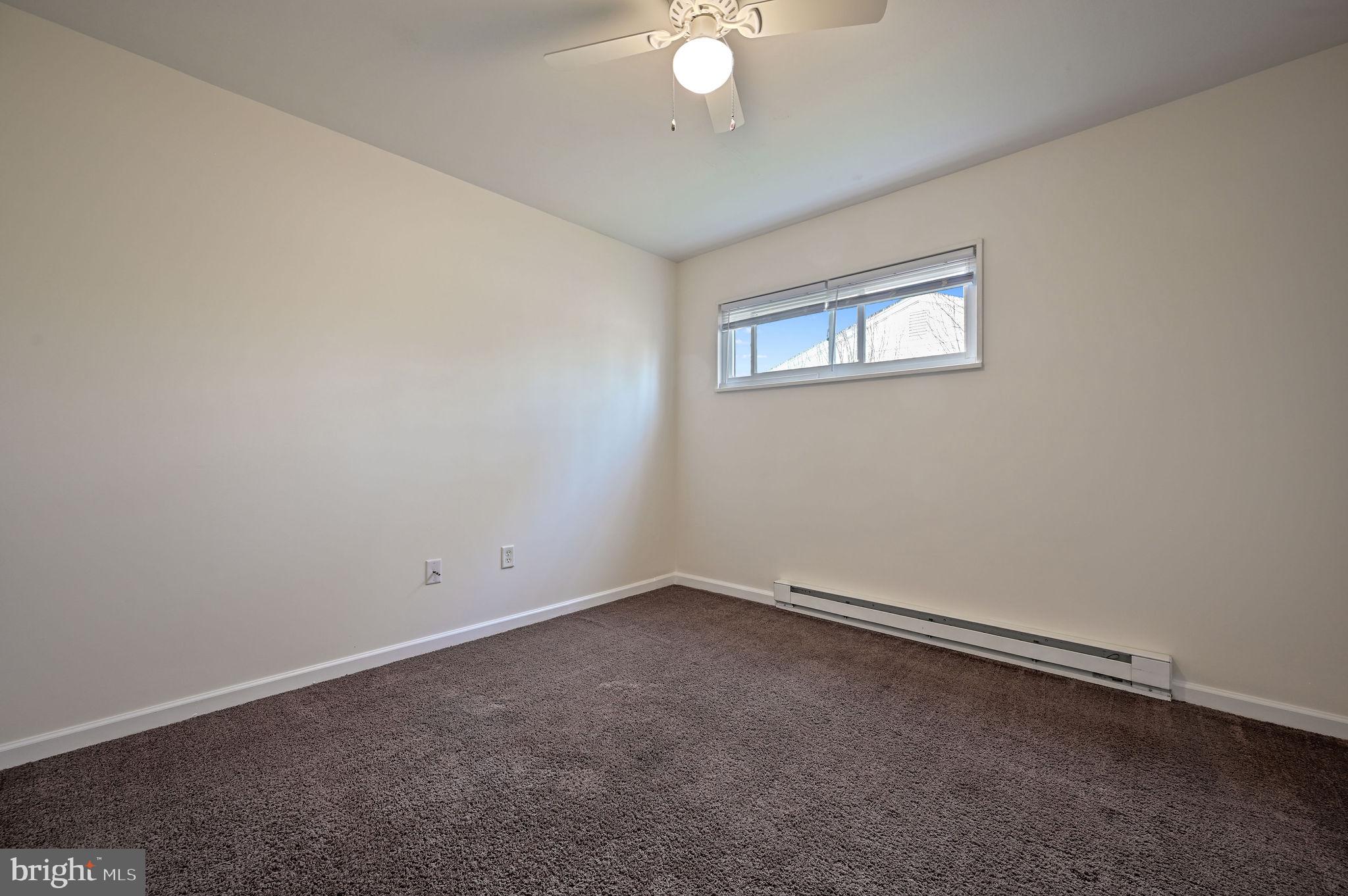 1431 Joshua Clayton Road Dover, DE 19904 - Photo 21 of 31 an empty room with a chandelier fan