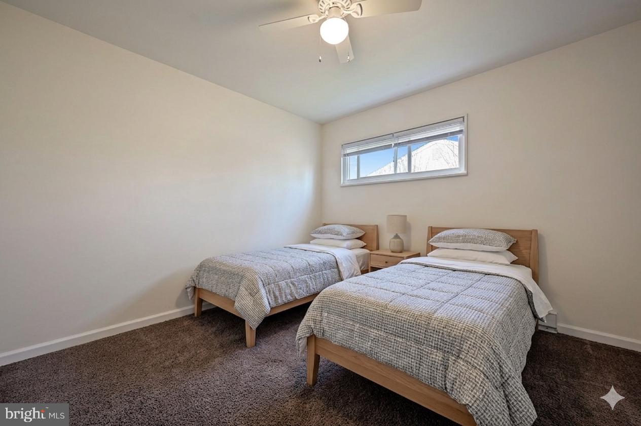 1431 Joshua Clayton Road Dover, DE 19904 - Photo 22 of 31 a bedroom with two beds and a chandelier
