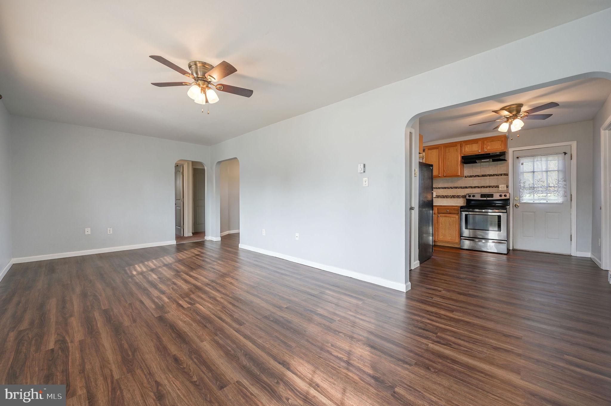1431 Joshua Clayton Road Dover, DE 19904 - Photo 4 of 31 a view of a livingroom with wooden floor and staircase