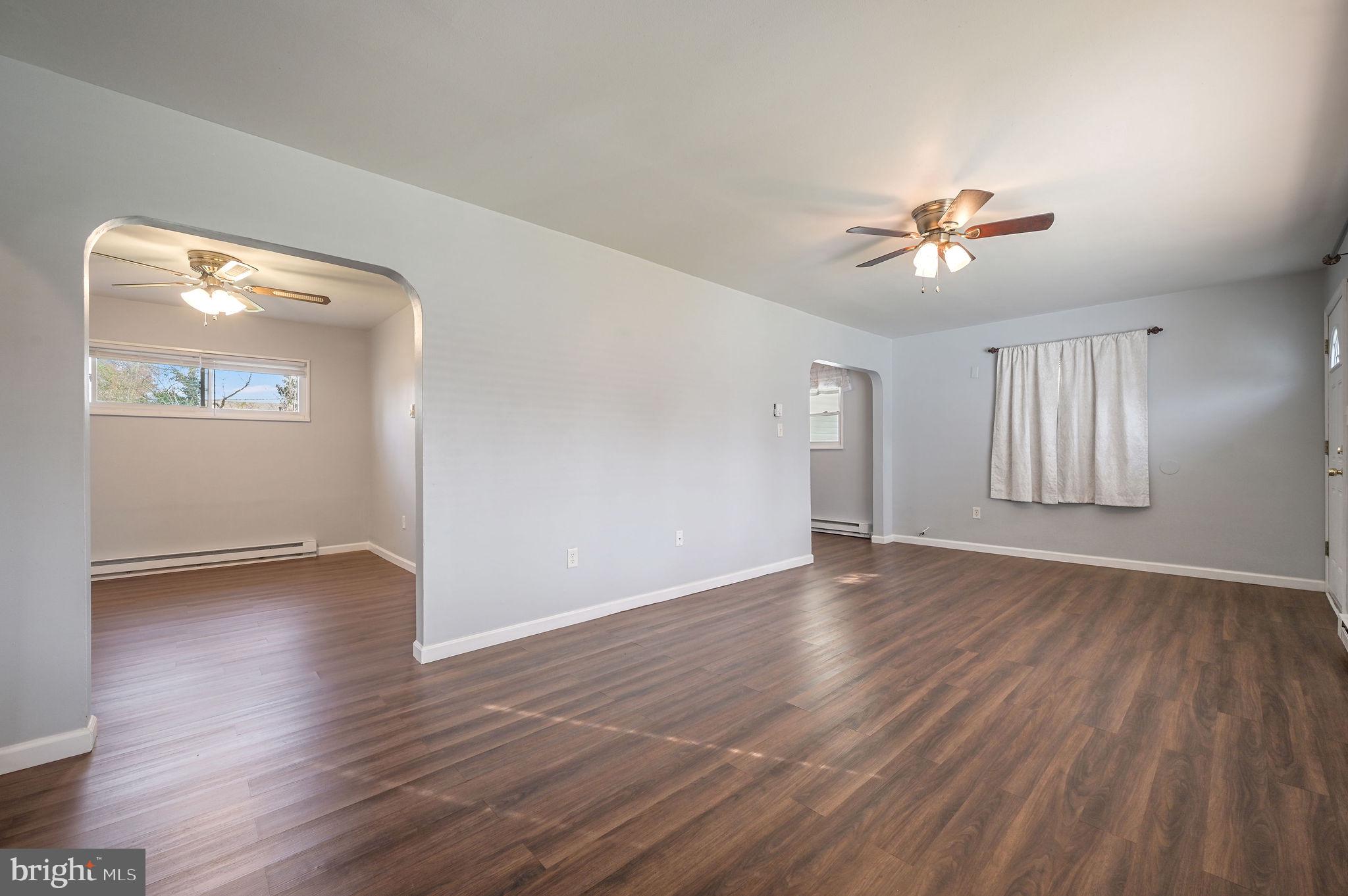 1431 Joshua Clayton Road Dover, DE 19904 - Photo 6 of 31 an empty room with wooden floor and windows