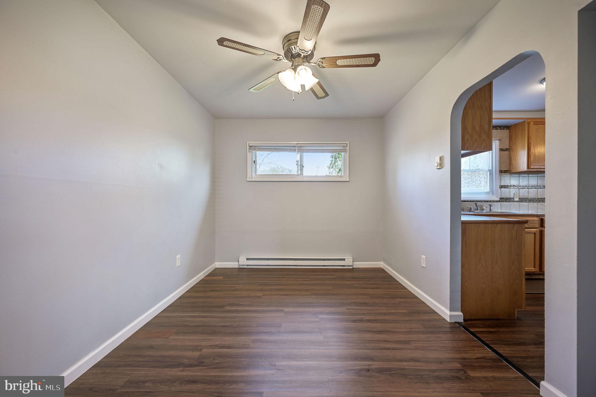 1431 Joshua Clayton Road Dover, DE 19904 - Photo 7 of 31 wooden floor in an empty room with a window