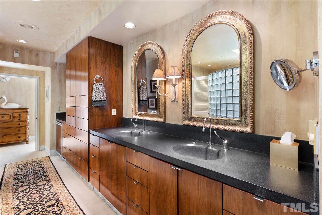 126 Hagwood Road Zebulon, NC 27597 - Photo 16 of 30 a bathroom with a granite countertop sink a large mirror and shower