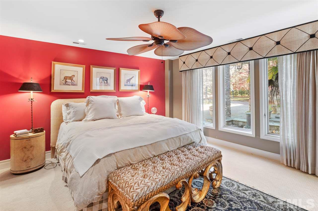 126 Hagwood Road Zebulon, NC 27597 - Photo 20 of 30 a bedroom with a bed and a chandelier