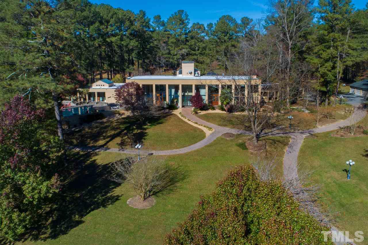 126 Hagwood Road Zebulon, NC 27597 - Photo 25 of 30 a view of a house with pool and trees around