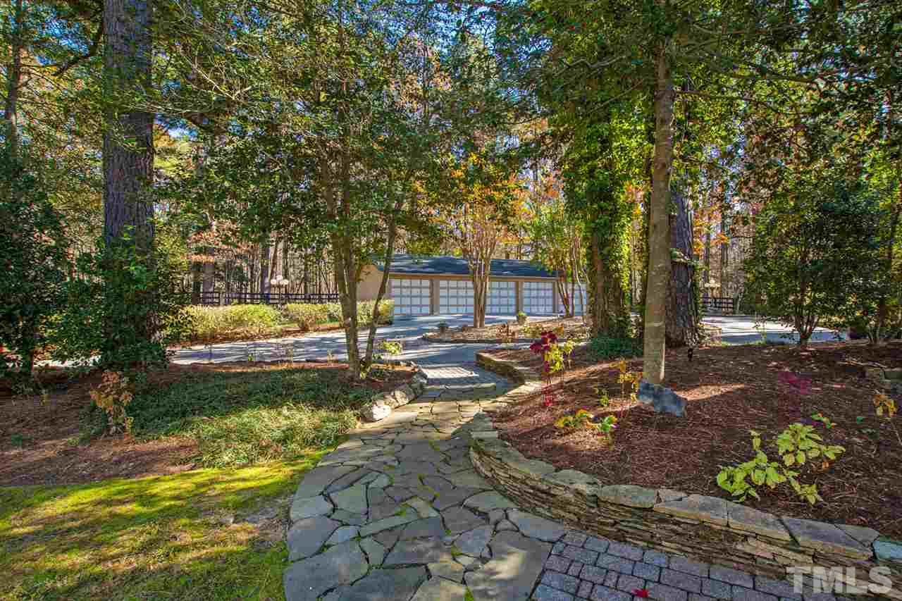 126 Hagwood Road Zebulon, NC 27597 - Photo 29 of 30 a view of a yard with plants and large trees