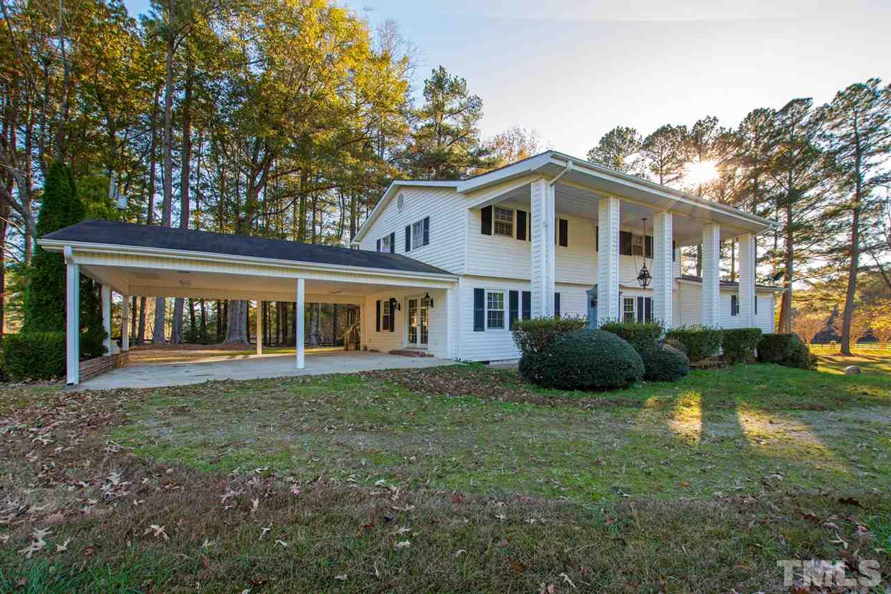 126 Hagwood Road Zebulon, NC 27597 - Photo 30 of 30 a view of a house with a big yard and large trees