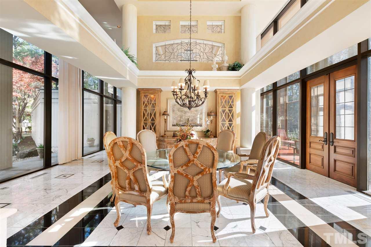 126 Hagwood Road Zebulon, NC 27597 - Photo 5 of 30 a view of a dining room with furniture a chandelier and large windows