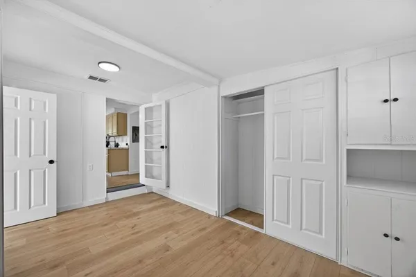 a view of empty room with wooden floor
