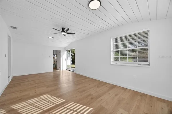 wooden floor in an empty room with a window