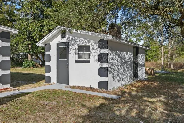 a view of a house with a yard and garage