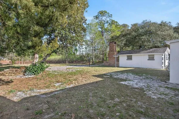a view of a house with a yard and garage