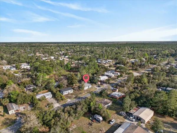 an aerial view of residential houses with city view