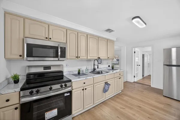 a kitchen with stainless steel appliances a stove microwave and cabinets