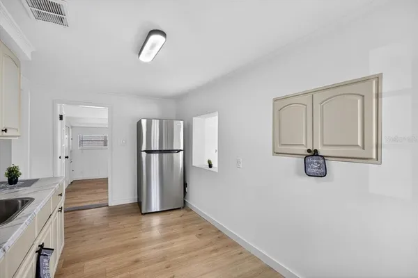 a view of a livingroom with wooden floor and a ceiling fan