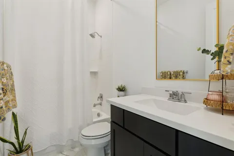 a bathroom with a sink toilet and a mirror
