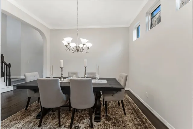 a view of a dining room with furniture and chandelier