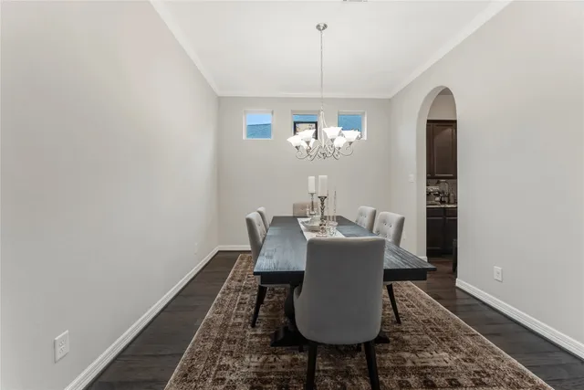 a dining room with furniture and chandelier