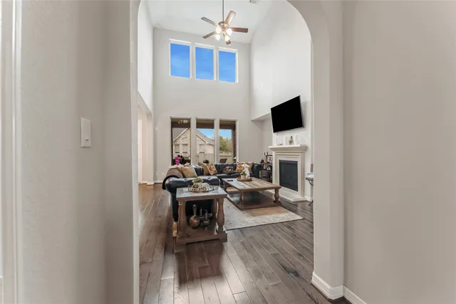 a living room with furniture a fireplace and a flat screen tv