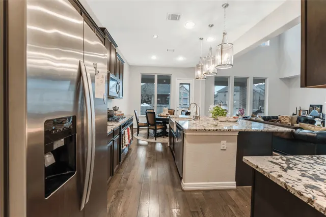 a kitchen with lots of counter top space and stainless steel appliances