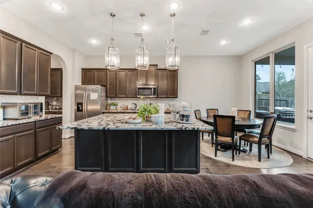 a kitchen with kitchen island granite countertop a sink and stove