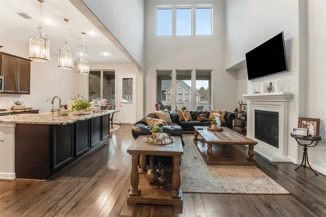 a living room with furniture a fireplace and a flat screen tv