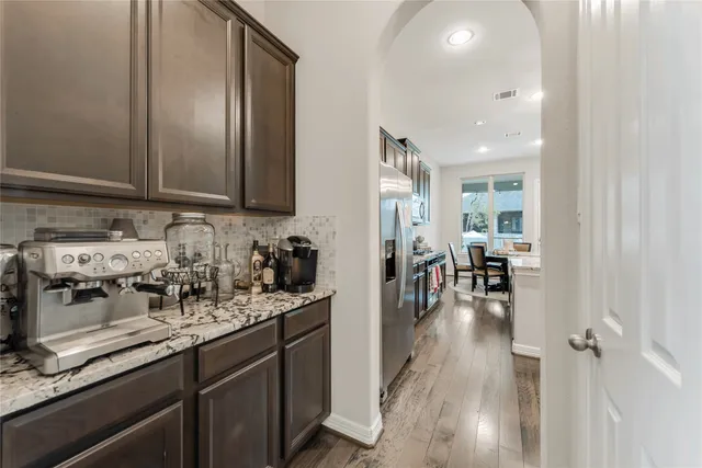 a kitchen with sink refrigerator and cabinets