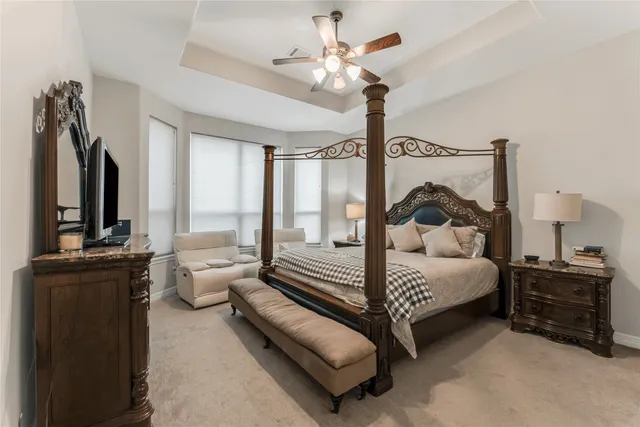a bedroom with bed and a chandelier