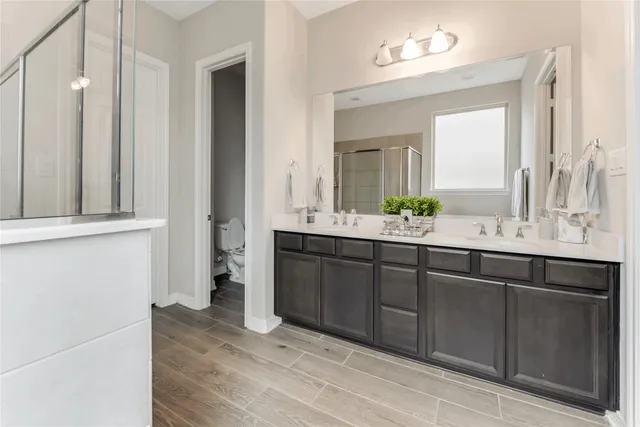 a bathroom with a double vanity sink and a mirror