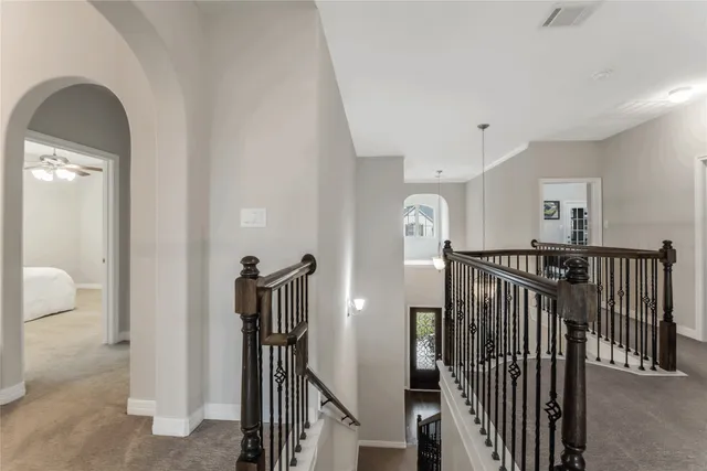 a view of a hallway with paintings on the wall